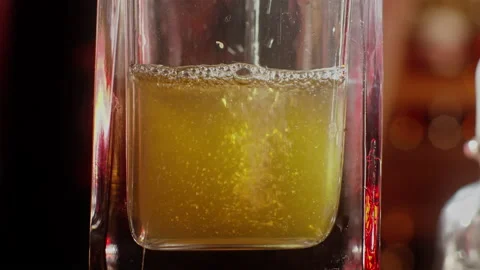 Man pouring colored liquid into a bottle Stock Footage 255701773