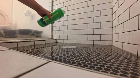 Man pouring declogger in clogged shower drain San Francisco CA USA July 29 2025 Stock-Footage 313957459