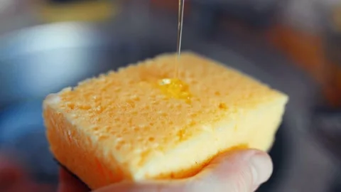 Man pouring detergent on a litchen sponge closeup. Home routine,everyday life co Video stock 304752304