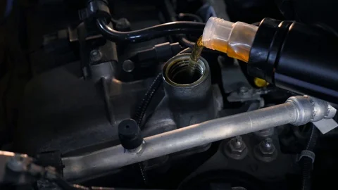 Man pouring in engine oil close up high angle 4k Stock Footage 86069284