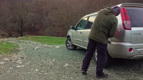 Man pouring gasoline into an empty fuel tank from a plastic red gas can Stock-Footage 224063930