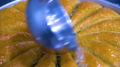 The man is pouring grape into baklava. Video stock 106019666