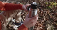 Crop Woman Pouring Hot Drink From Thermos by Stocksy Contributor