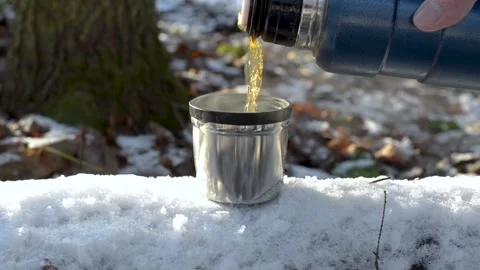 Man pouring hot tea into mug from thermos. 스톡 동영상 145270644