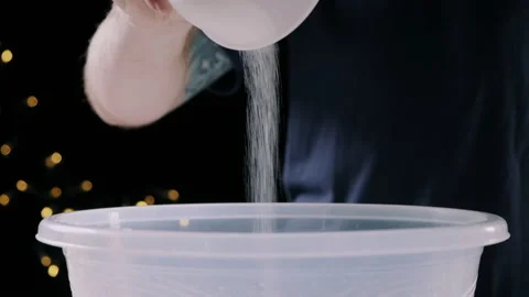 Man pouring ingredients into a large plastic bowl Video stock 132819411