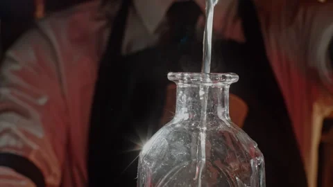 Man pouring liquid into a bottle Stock Footage 255702298