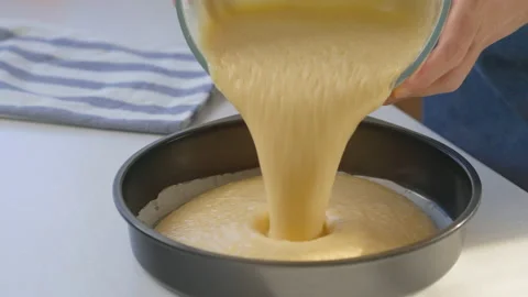 Man pouring mixture into a cake pan Stock Footage 200716061