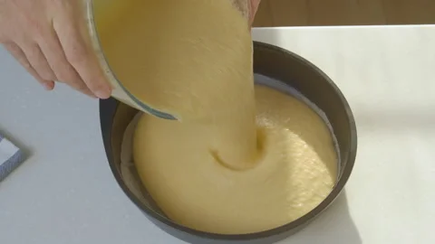Man pouring mixture into a cake pan Video stock 201589988