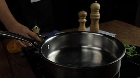 Man pouring olive oil on a pan. Stock Footage 118019727