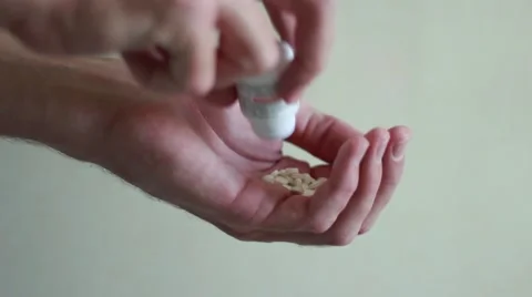Man pouring out tablets in hands Vídeo Stock 63455668