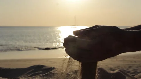 A man pouring the sand from his hands Stock Footage 64212740