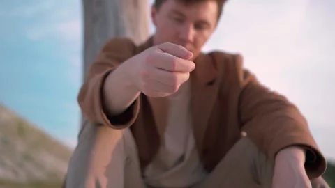 Man Pouring Sand Through His Fingers, Slow Motion Stock Footage 138260159