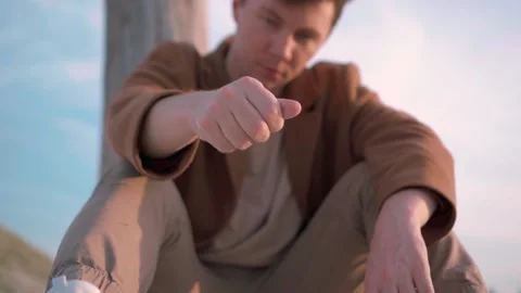 Man Pouring Sand Through His Fingers, Slow Motion Stock Footage 138260243