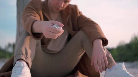 Man Pouring Sand Through His Fingers, Slow Motion Stock Footage 138260246