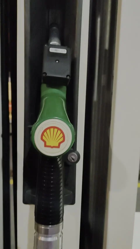 Man pouring shell petrol on motorcycle gas Stock Footage 164607768