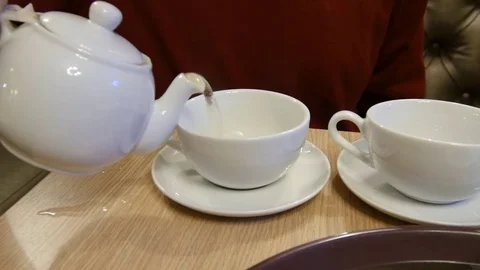 Man pouring tea into a cup 스톡 동영상 76254999