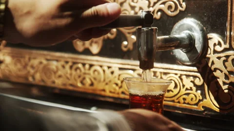 Man Pouring the Tea in a Cup Stock Footage 268756843