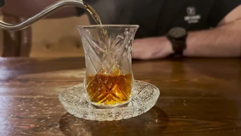 A Man Pouring Tea İnto A Glass Stock Footage 296441990