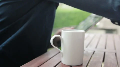 Man pouring tea holding his tablet Stock Footage 40664591