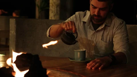 Man pouring tea in restaurant. Stock Footage 273484935