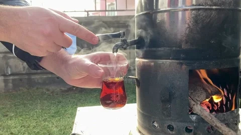 Man pouring tea from a samovar Stock Footage 203886818