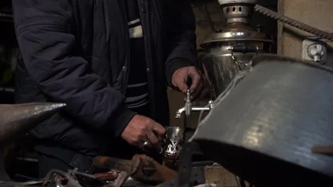 Man Pouring Tea from Samovar with Teapot 動画素材 251541700