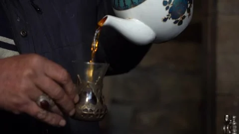 Man Pouring Tea from Teapot Stock Footage 251541696