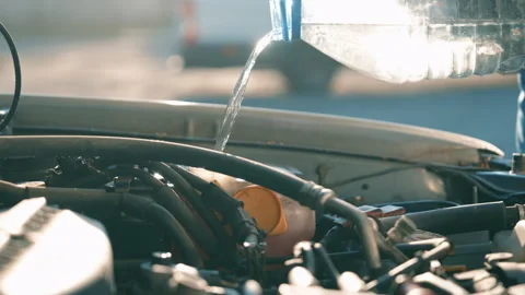 Man Pouring Water Into Windshield Washer Fluid Reservoir | Refilling Car Engine Stock Footage 339738788