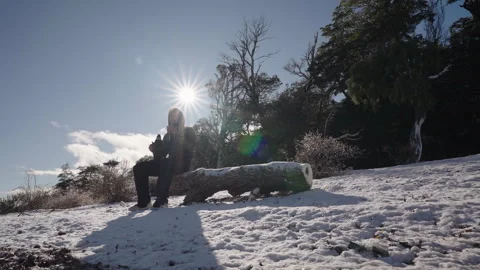Man Pouring Yerba Mate on Log in Snowy Forest, Winter Silhouette Stock Footage 327443949