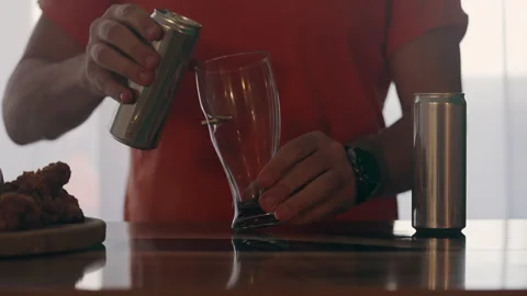A man pours beer into a glass. Stock Footage 281863394