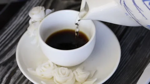 A man pours boiling water in a cup of instant coffee. Close-up shot. Stock Footage 135270476