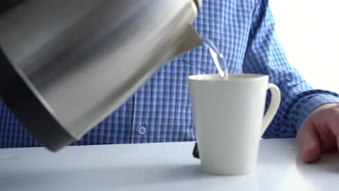 A man pours boiling water from an Stock Video Pond5