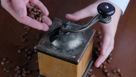 A man pours coffee beans into a coffee grinder, closeup Stock Footage 150315731