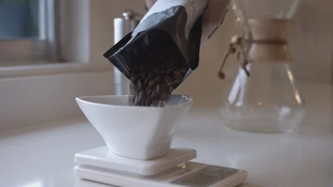 Man Pours Coffee Beans onto a Scale Stock Footage 90983334
