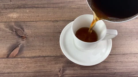 A man pours coffee into a cup. Stock Footage 237447004