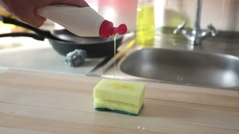Man pours detergent onto a sponge brush Stock-Footage 143149058