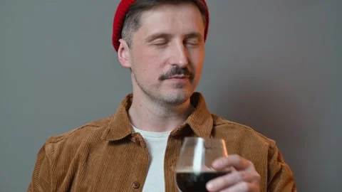 A man pours a drink from a alcohol bottle into a glass, showing happiness and Vidéo 337643290