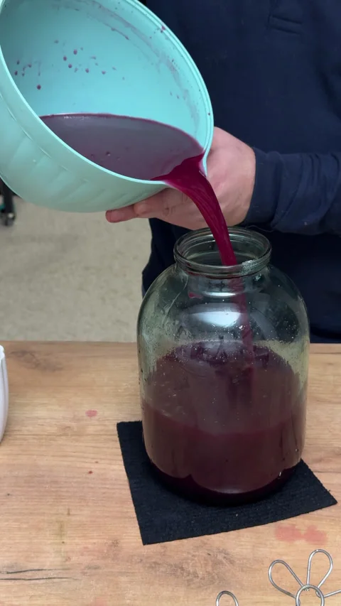 A man pours fermented grape juice into a jar for further fermentation, maki.. Stock Footage 321121817