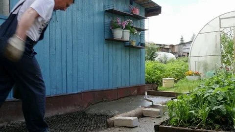 Man pours foundation from bucket Stock Footage 80295116