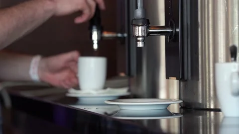 A man pours himself coffee from a special coffee machine Stock Footage 157015663