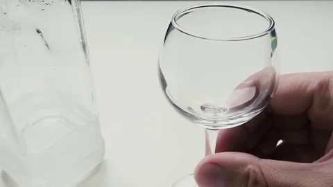 Man pours himself a glass of vodka Stock-Footage 77300261