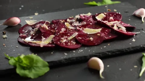 Man pours olive oil on beetroot carpaccio. Vegan food. Stock Footage 154533988
