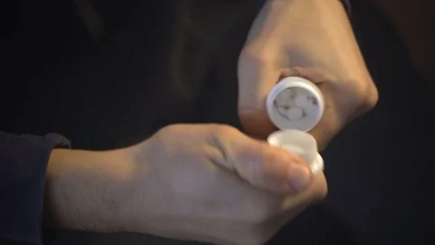 Man pours into the palm of tablets Stock Footage 71748197