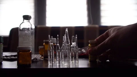 Man pours pills on table Stock Footage 125809744