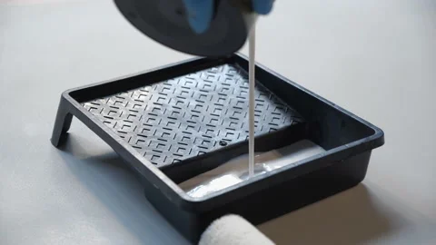 Man pours the primer into a plastic roller pan. paint bath Stock Footage 157429088