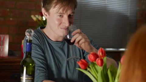 Man Pours Rose Petal on Table and Drinks a Sip of Wine Stock Footage 59348438