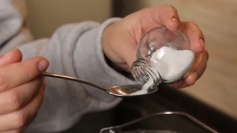 Man pours sugar on a spoon from the jar Stock-Footage 69910798