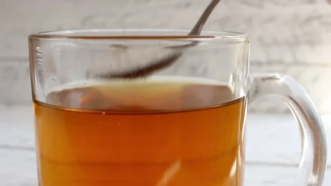 The man pours sugar into tea. A cockroach swims in tea Stock Footage 134332718