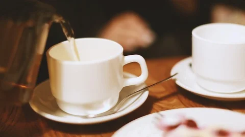 Man pours tea into a Cup Stock Footage 104144402