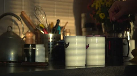 Man pours tea in mugs Stock Footage 58034979